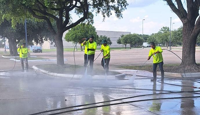 Facility support crew carrying out exterior cleaning